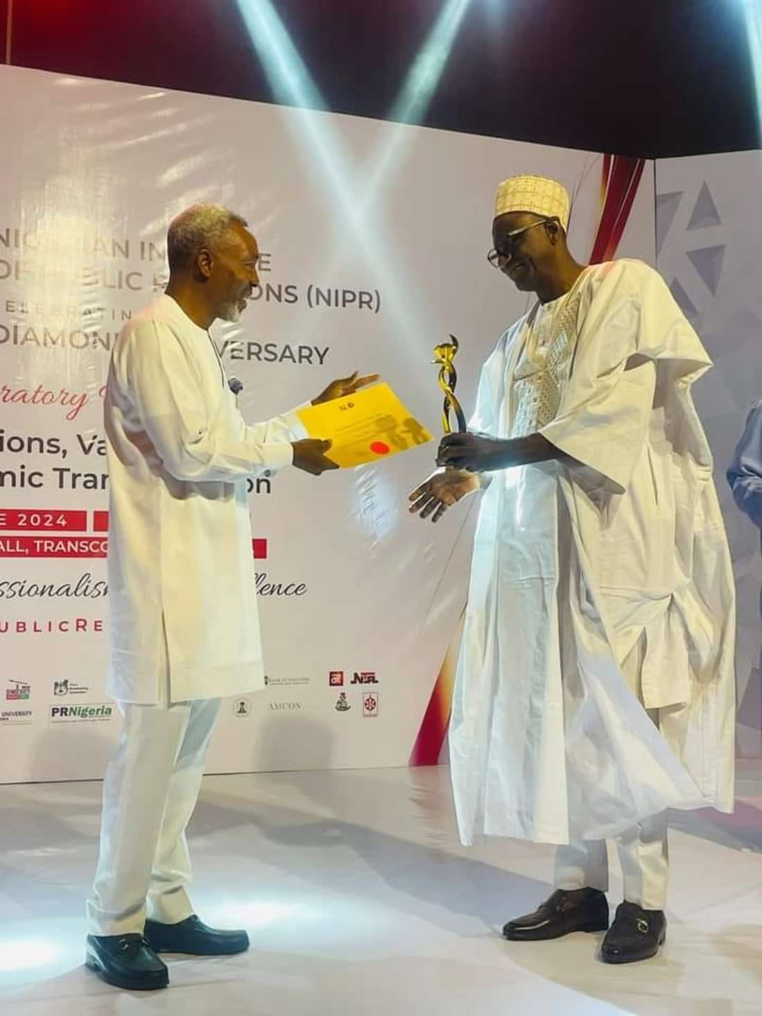 Muhammad Dattijo Usman receiving an award at a professional event